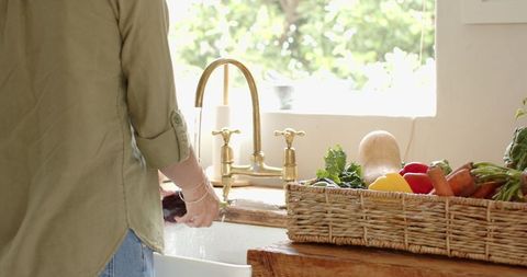 Rinsing Fresh Produce in Rustic Farmhouse Kitchen