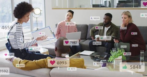 Diverse Team Engaged in Creative Discussion with Social Media Icons