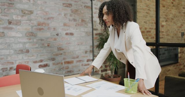 Focused Businesswoman Analyzing Documents in Modern Office - Download Free Stock Images Pikwizard.com