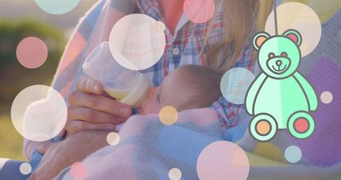 Mother Bonding with Baby Amid Playful Illustrations