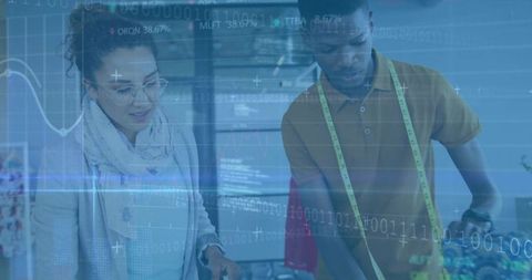 Fashion designers collaborating on garment with digital technology