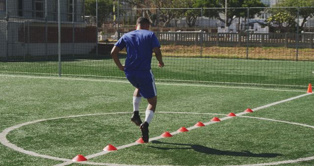 Soccer Player Training with Cones on Artificial Turf Field - Download Free Stock Images Pikwizard.com