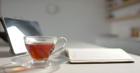 Tranquil workspace with tea and open notebook