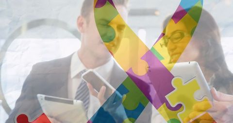 Business professionals engaging with autism puzzle ribbon overlay