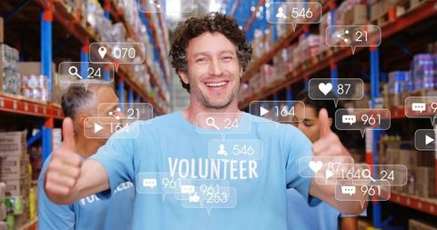 Cheerful Volunteers in Warehouse Boosting Social Media Engagement