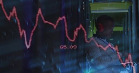 IT Professional Analyzing Data in Server Room with Stock Market Trends