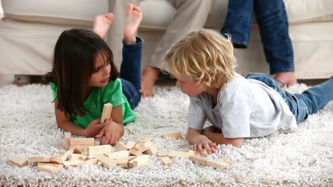 Children Enjoying Playtime with Building Blocks on Carpet