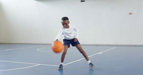 Energetic Young Boy Practicing Basketball Dribbling Skills