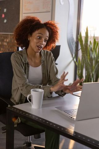 Confident Woman Engaging in Video Call in Casual Office