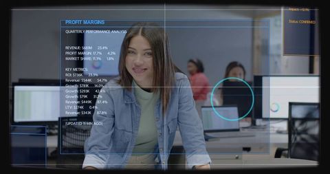 Analyst reviewing profit margins on transparent dashboard in open office environment