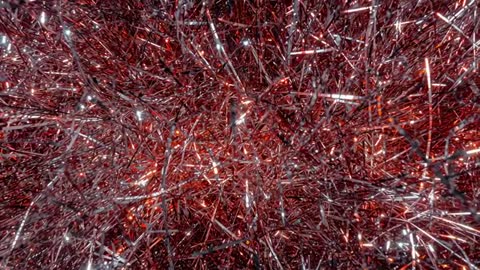 Close-up moving red and silver tinsel shimmering and glinting with sparkling highlights
