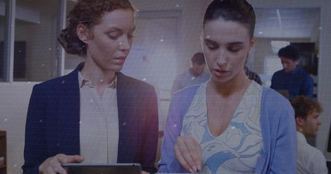 Professional colleagues collaborating in contemporary open office environment