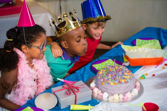 Boy blowing candles on cake during birthday