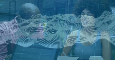 Collaborating over digital wave data with holographic grid overlay in modern workspace