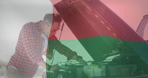 Man performing car maintenance on suv, outdoor exploration