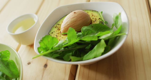 Image of bowls of fresh salad with green leaves on wooden background. fusion food, fresh vegetables and healthy eating concept.