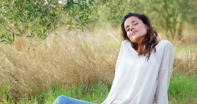 Relaxed Woman Enjoying Nature Outdoors in Sunny Field - Download Free Stock Images Pikwizard.com