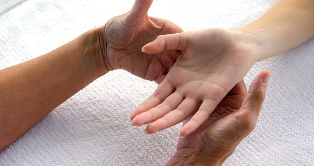 Senior Woman Holding Hand of Young Woman on White Towel - Download Free Stock Images Pikwizard.com