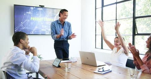 Diverse Team Celebrating Successful Product Launch in Office
