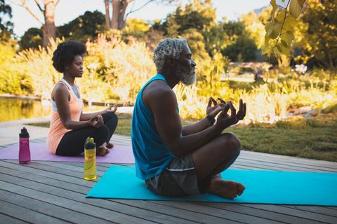 Senior Couple Meditating Outdoors During Peaceful Yoga Session