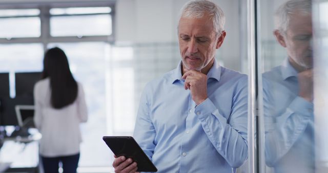 Senior Businessman Reading Document on Tablet in Office - Download Free Stock Images Pikwizard.com