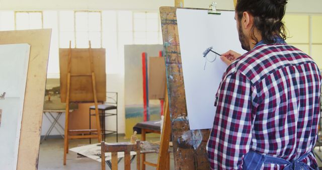 Male Artist Sketching on Canvas in Art Studio - Download Free Stock Images Pikwizard.com