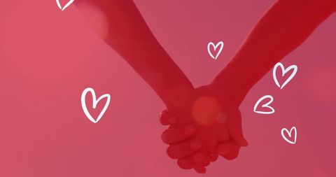 Romantic Couple Holding Hands Against Red Heart Background