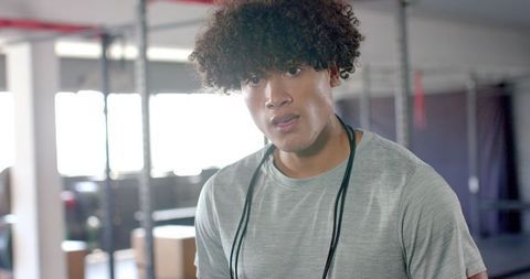 Focused athlete with jump rope in gym setting