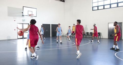 Energetic basketball game action in indoor gymnasium