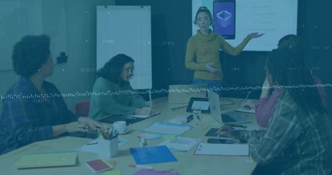 Businesswoman Engaging in Team Presentation With Collaborative Audience