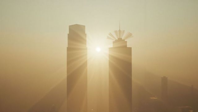 Glowing twin skyscrapers amid sunrise radiance