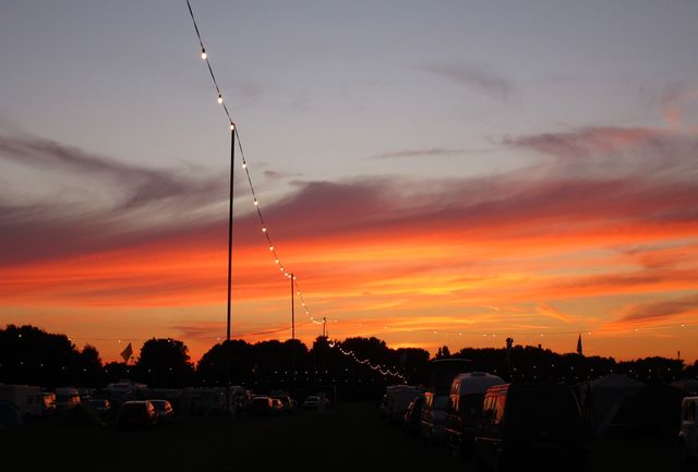 Vivid Sunset Sky Over Silhouetted Cityscape With Twinkling Lights - Download Free Stock Photos Pikwizard.com