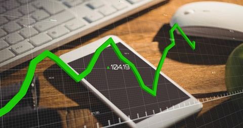 Mobile finance analytics with green growth chart overlapping smartphones on desk