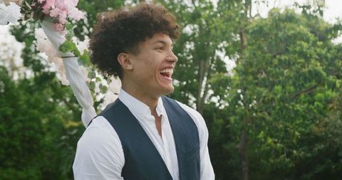 Joyful Man in Garden Celebrating Outdoor Wedding Ceremony