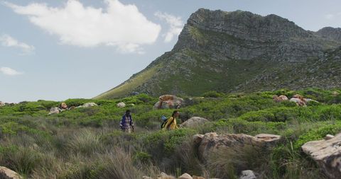 Couple Hiking Through Scenic Mountain Landscape