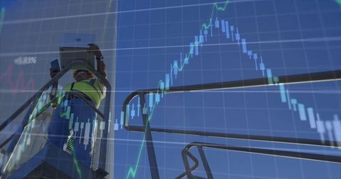 Industrial Worker Analyzing Data Overlaid with Financial Chart