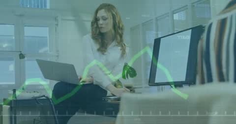 Businesswoman Using Laptop Analyzing Data on Graph Overlay