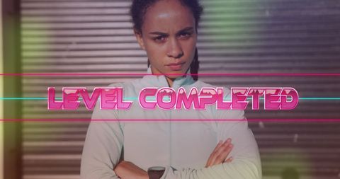 Determined fitness woman with level completed game graphic