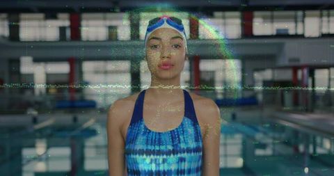 Confident female swimmer in vibrant tie-dye suit near pool
