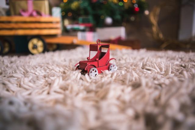 Toy car on fur carpet during christmas time
