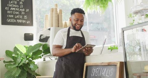 Barista Using Tablet at Chic Coffee Counter