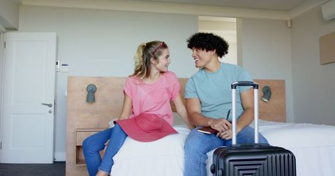 Couple Getting Ready for Vacation with Suitcase in Bedroom