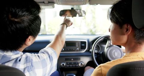 Teenage friends navigating car road trip together