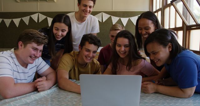 Excited Teenage Friends Gathered Around Laptop, Smiling and Laughing - Download Free Stock Images Pikwizard.com