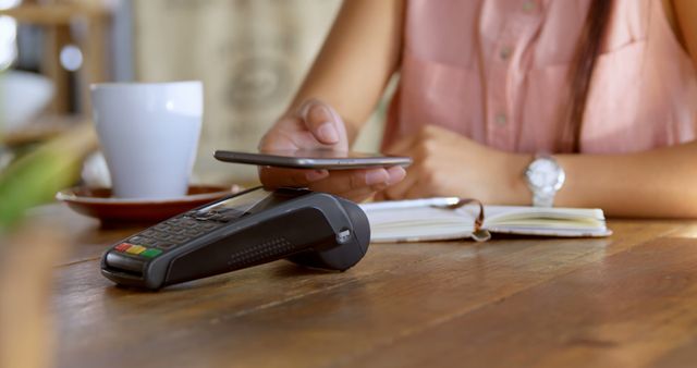 Woman Making Contactless Payment at Cafe with Smartphone - Download Free Stock Images Pikwizard.com