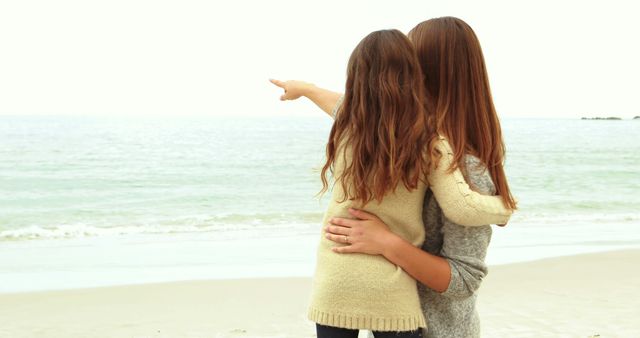 Mother and daughter looking at beach together - Download Free Stock Photos Pikwizard.com