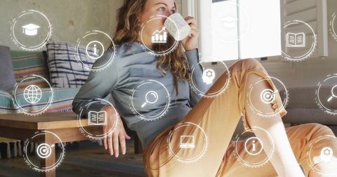 Young woman sipping coffee at home with floating digital learning and productivity icons