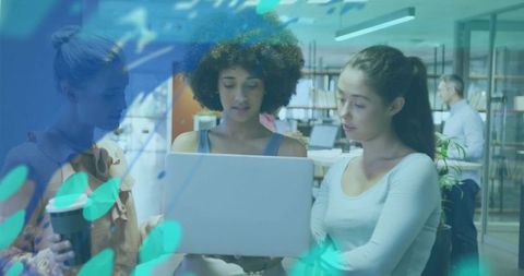 Young team collaborating over laptop in modern coworking office with turquoise overlay