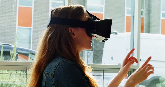 Woman Engaging with Virtual Reality Headset in Modern Space - Download Free Stock Images Pikwizard.com