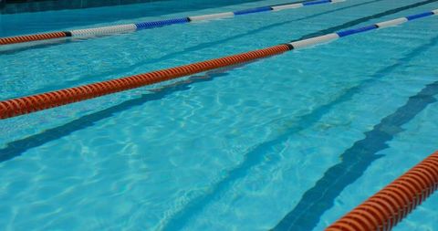 Sunny outdoor swimming pool with colorful lane dividers